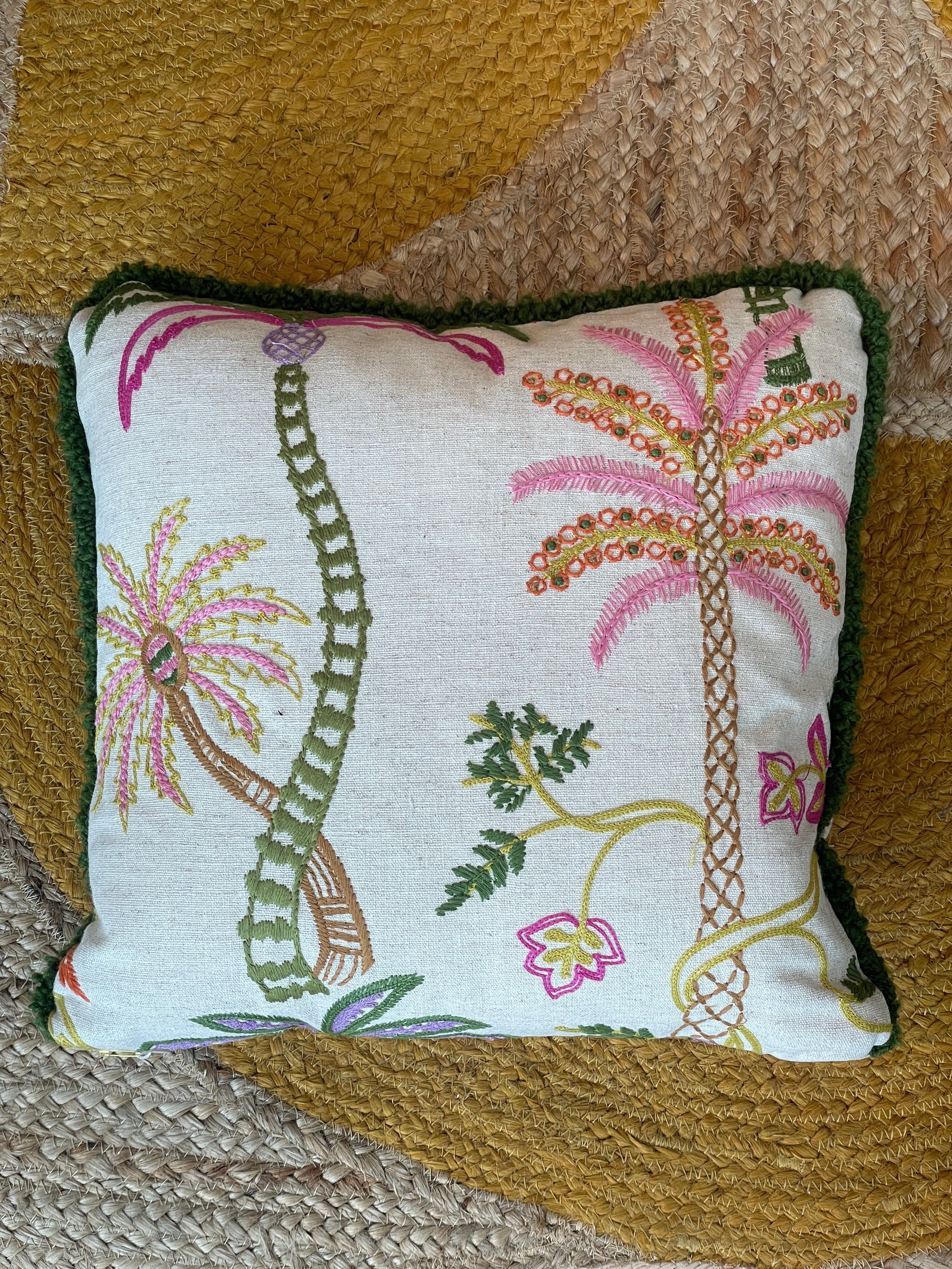 Hand-embroidered cushions with palm motifs