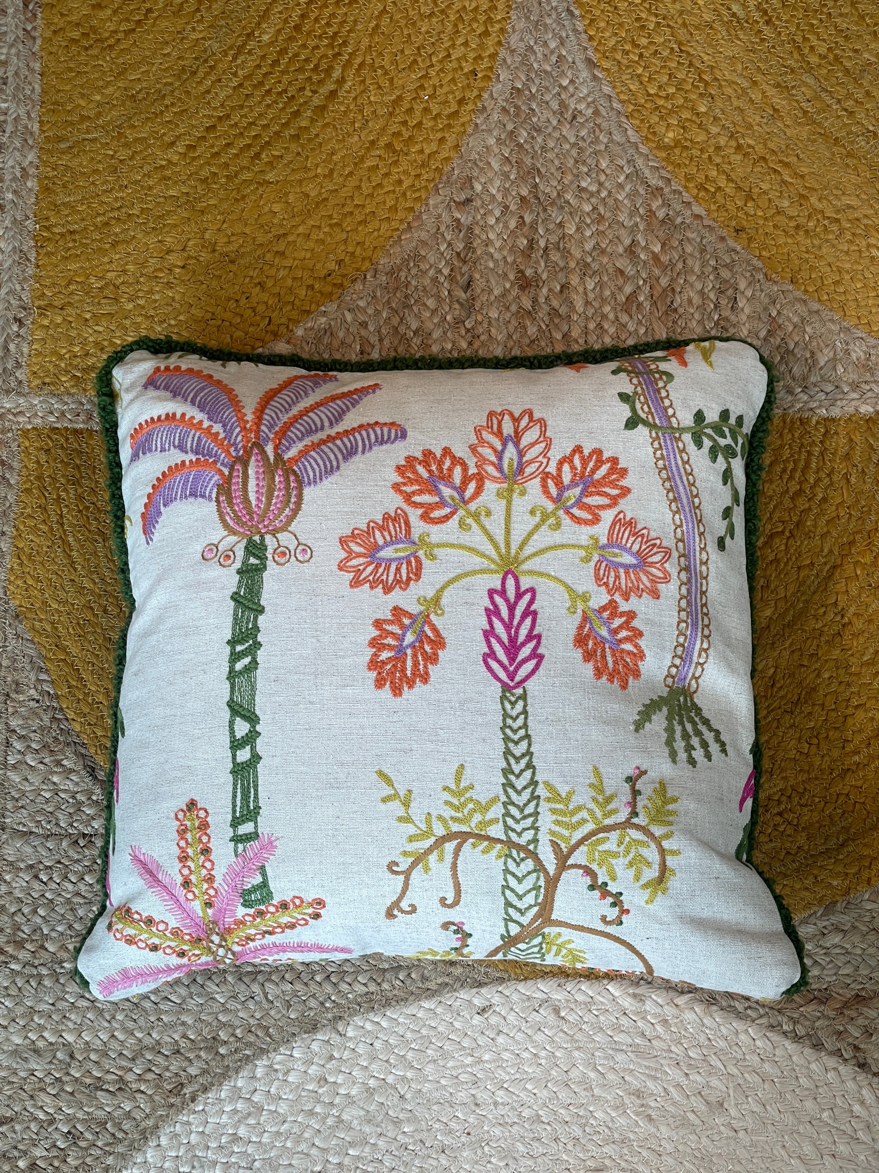 Hand-embroidered cushions with palm motifs