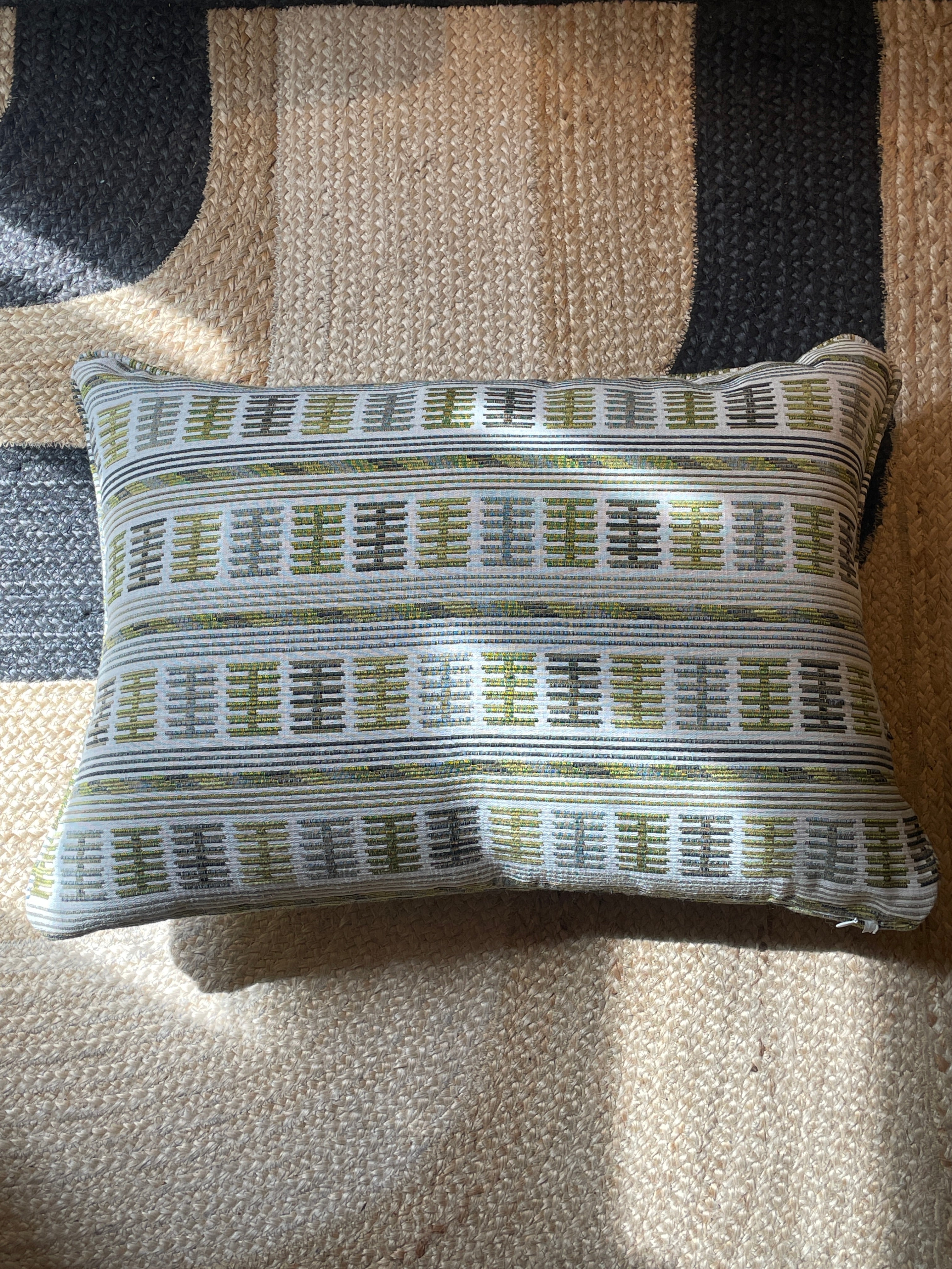 Embroidered cushion in shades of green