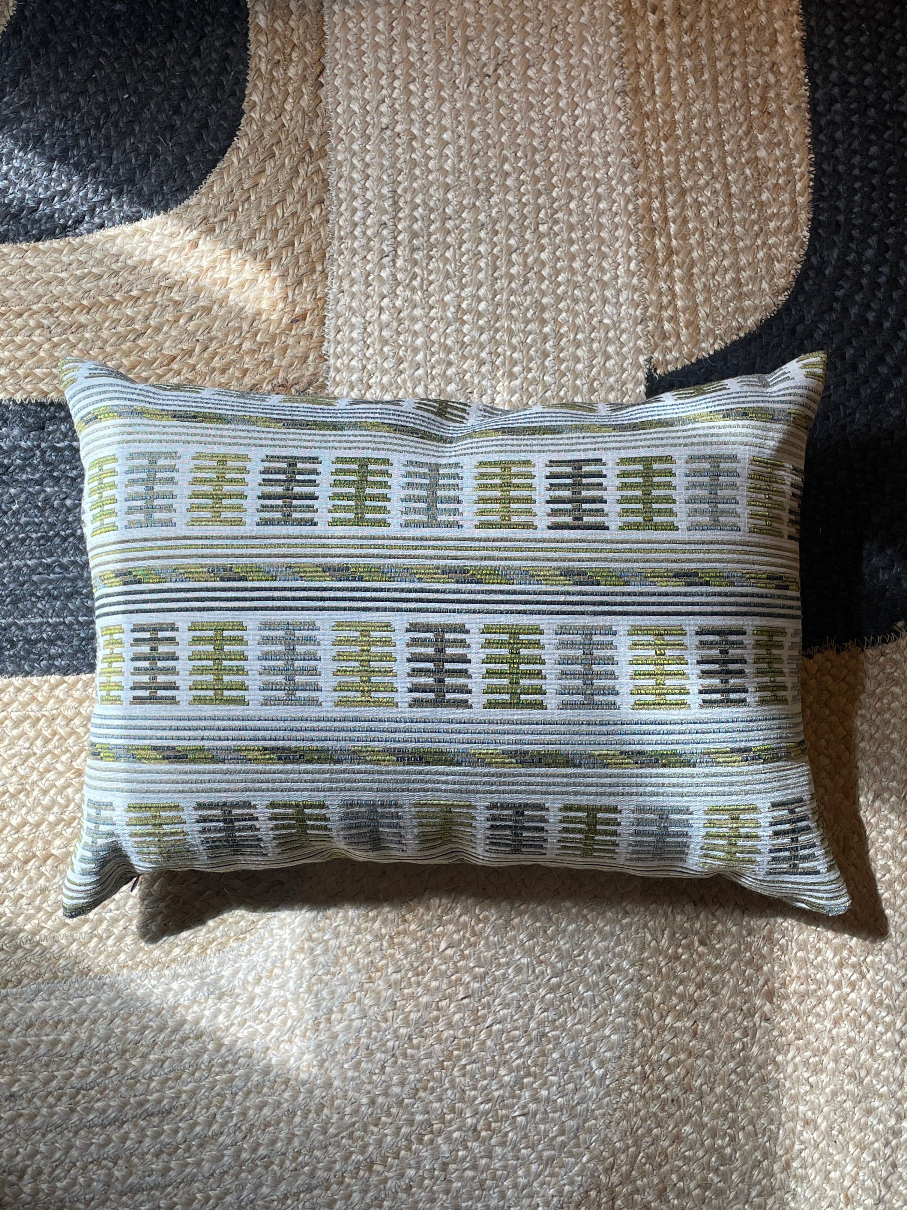 Embroidered cushion in shades of green