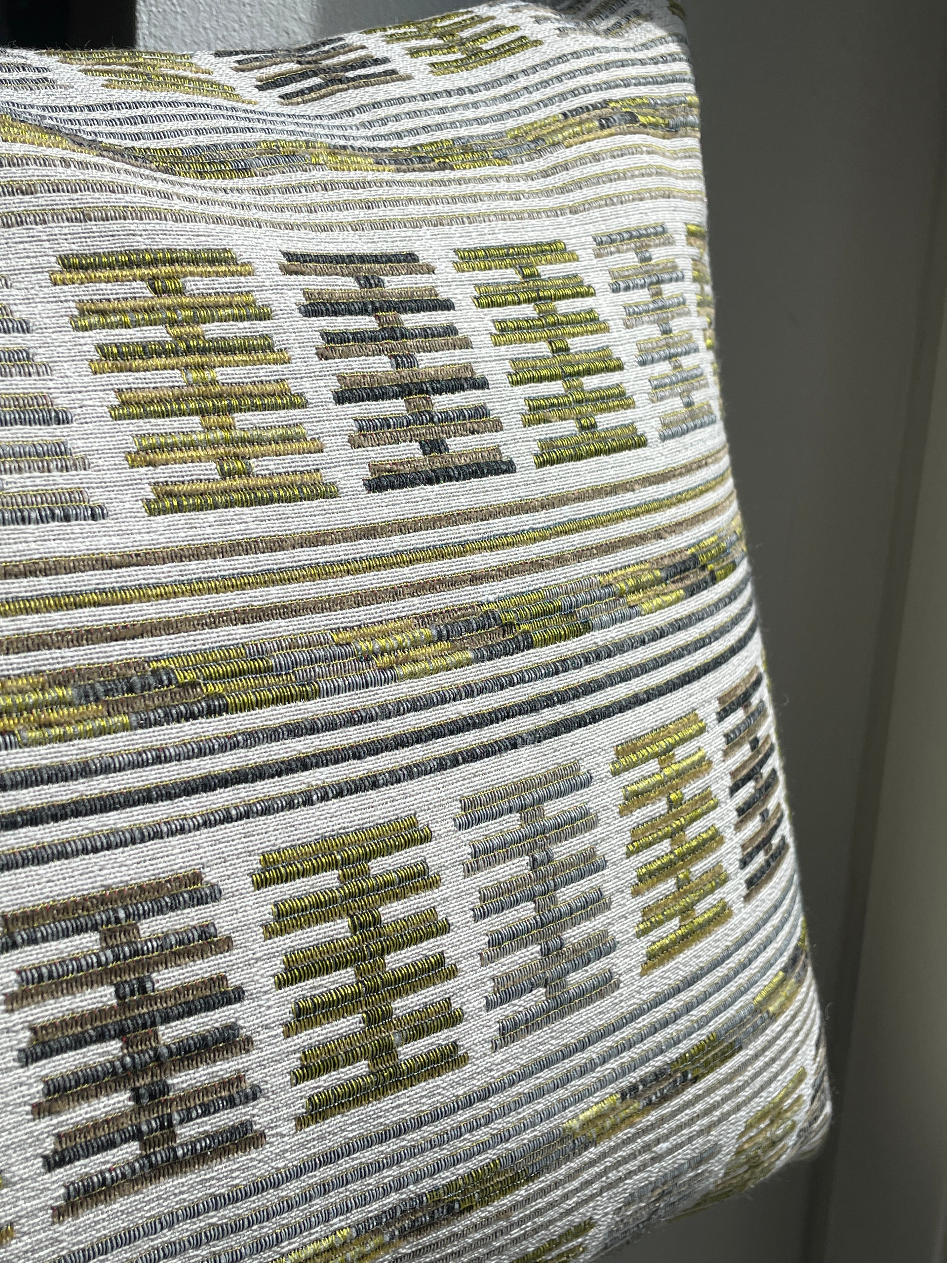 Embroidered cushion in shades of green