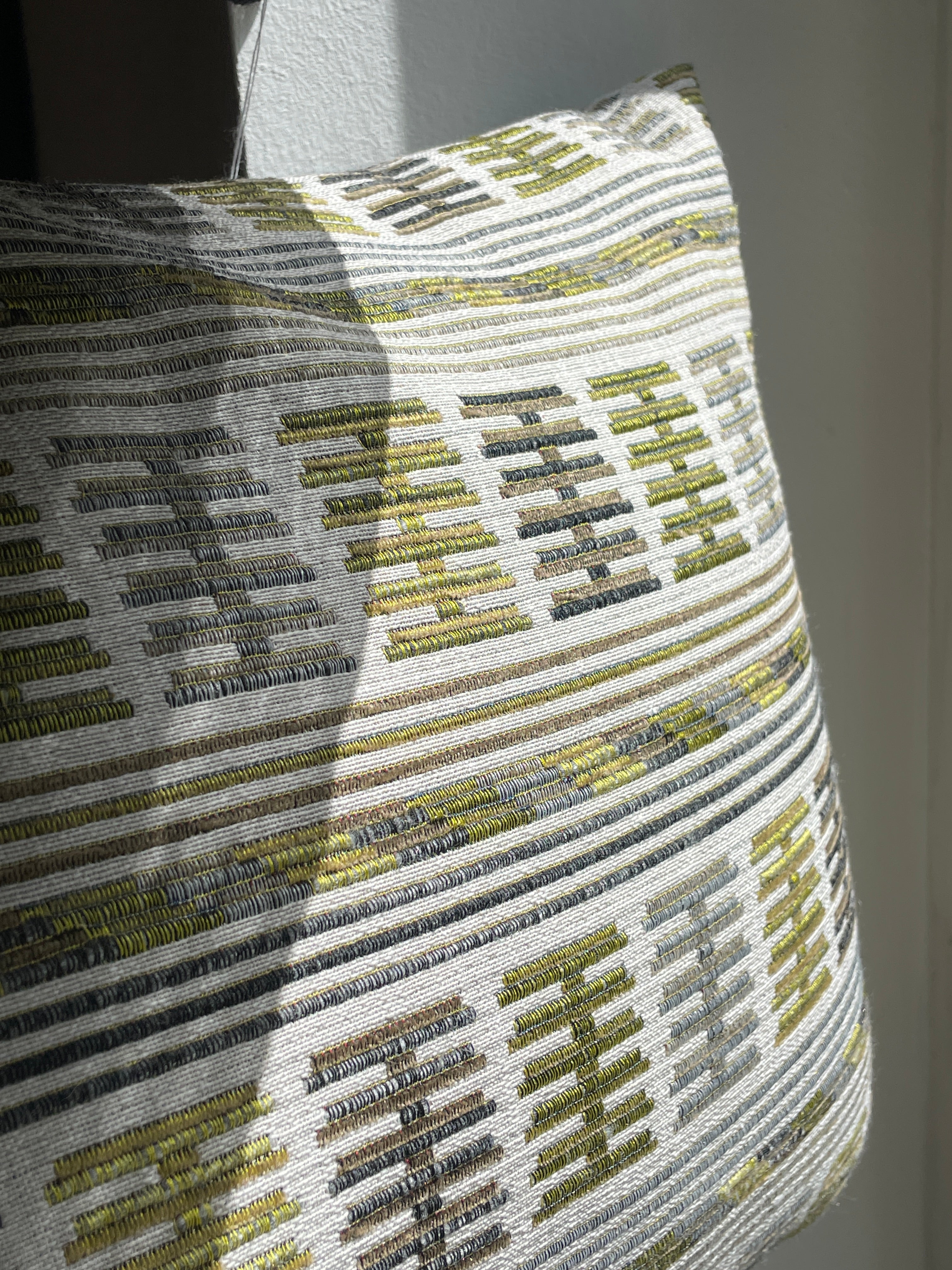 Embroidered cushion in shades of green