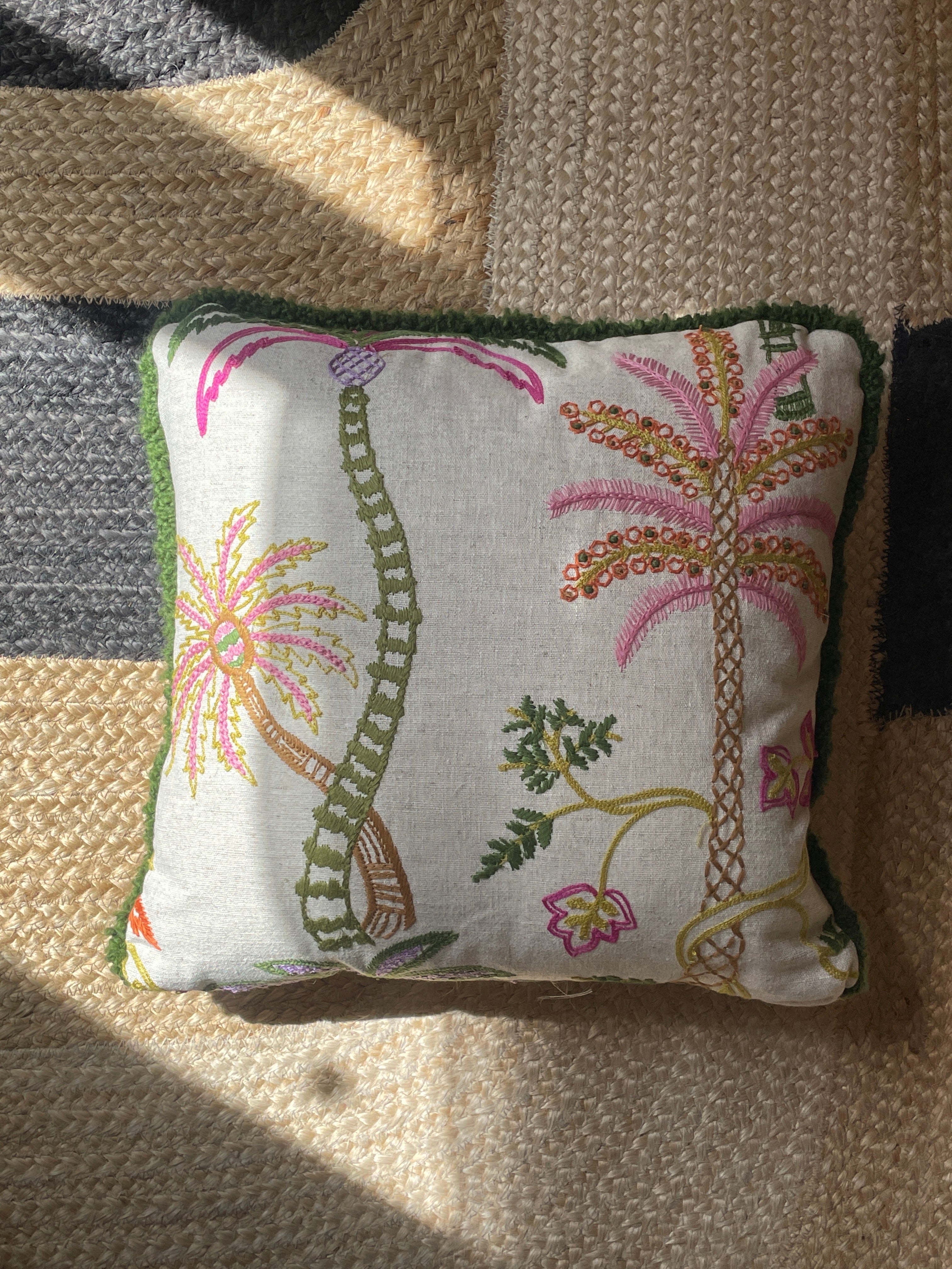 Hand-embroidered cushions with palm motifs