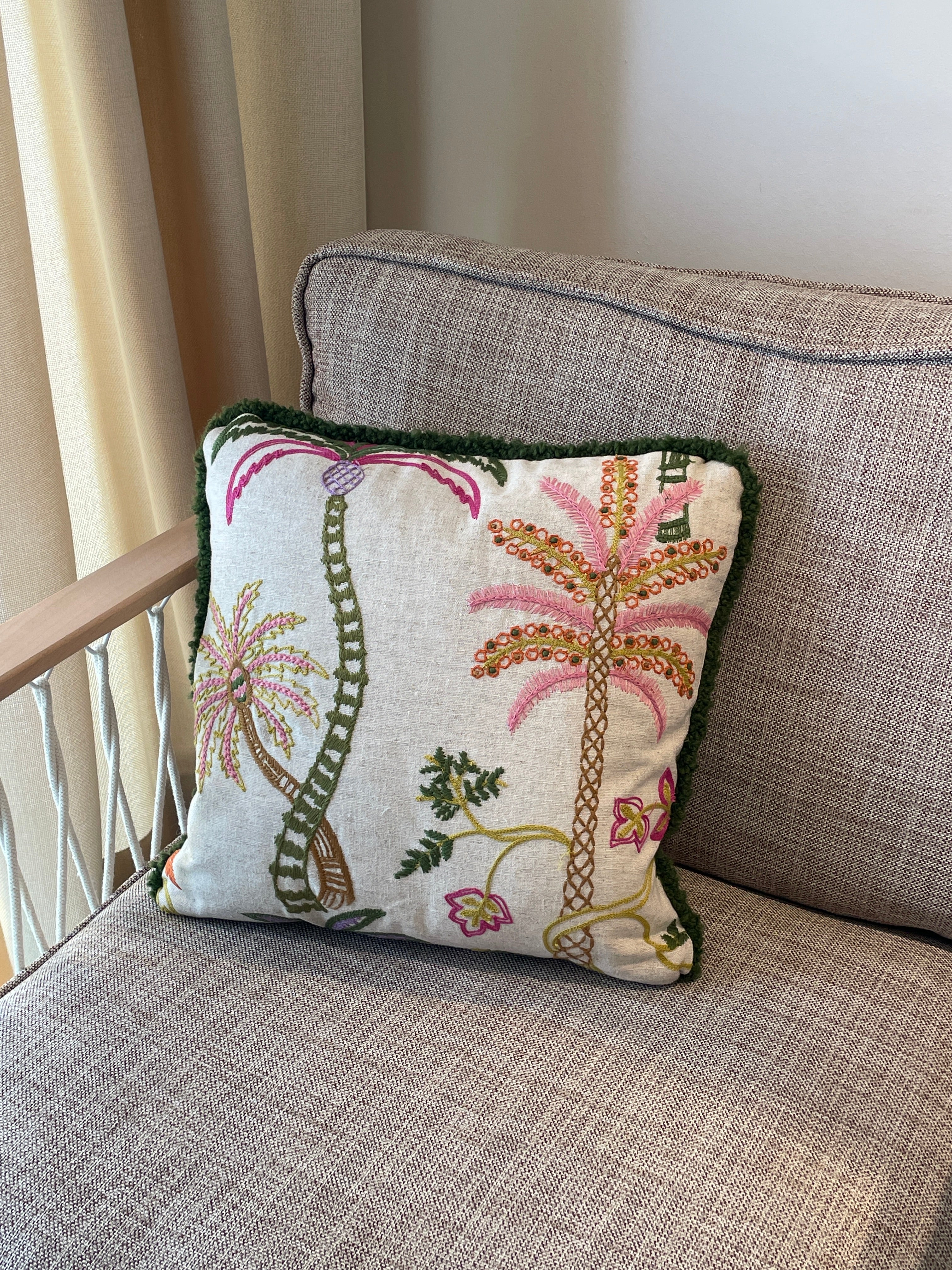 Hand-embroidered cushions with palm motifs