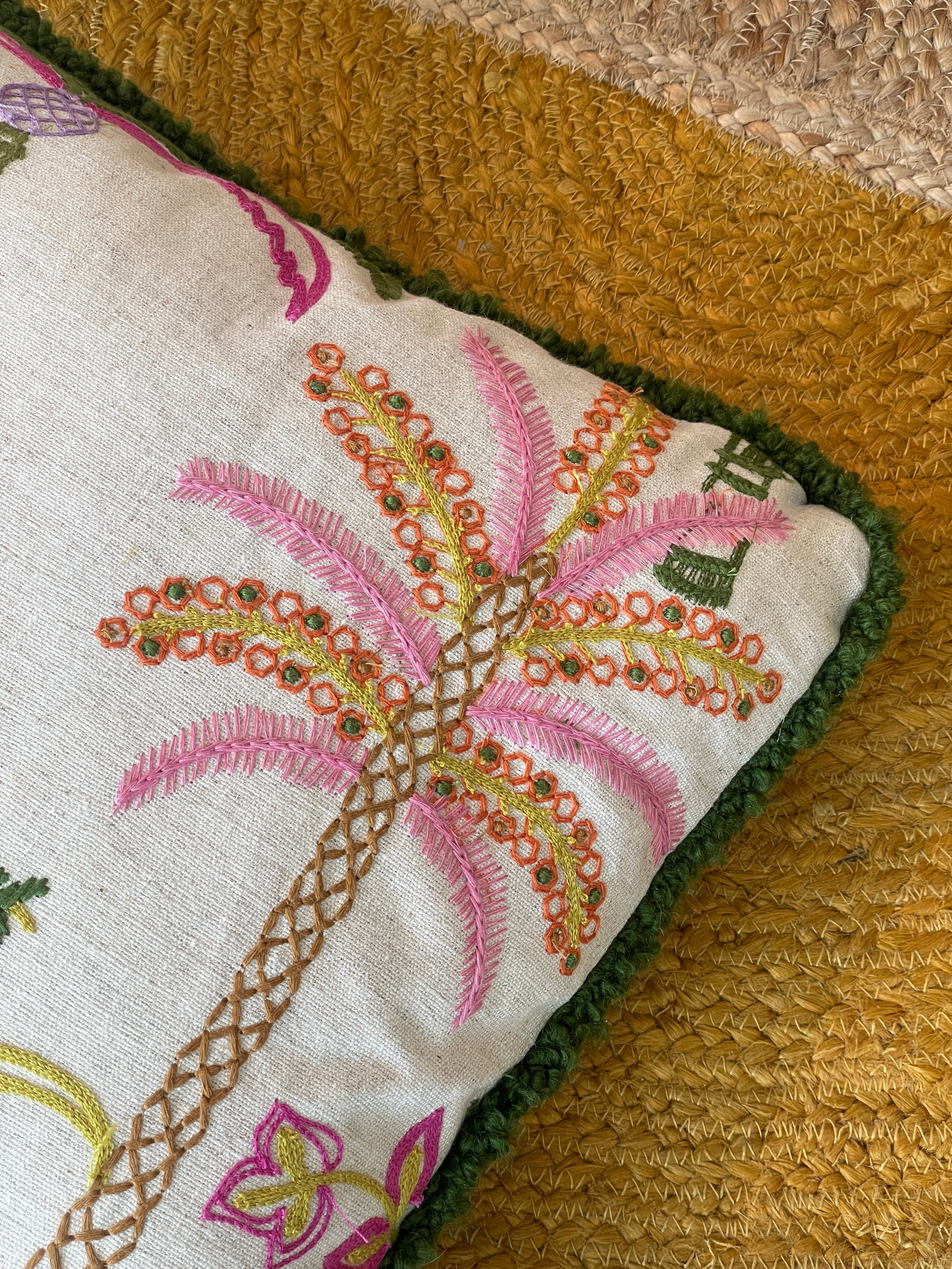 Hand-embroidered cushions with palm motifs