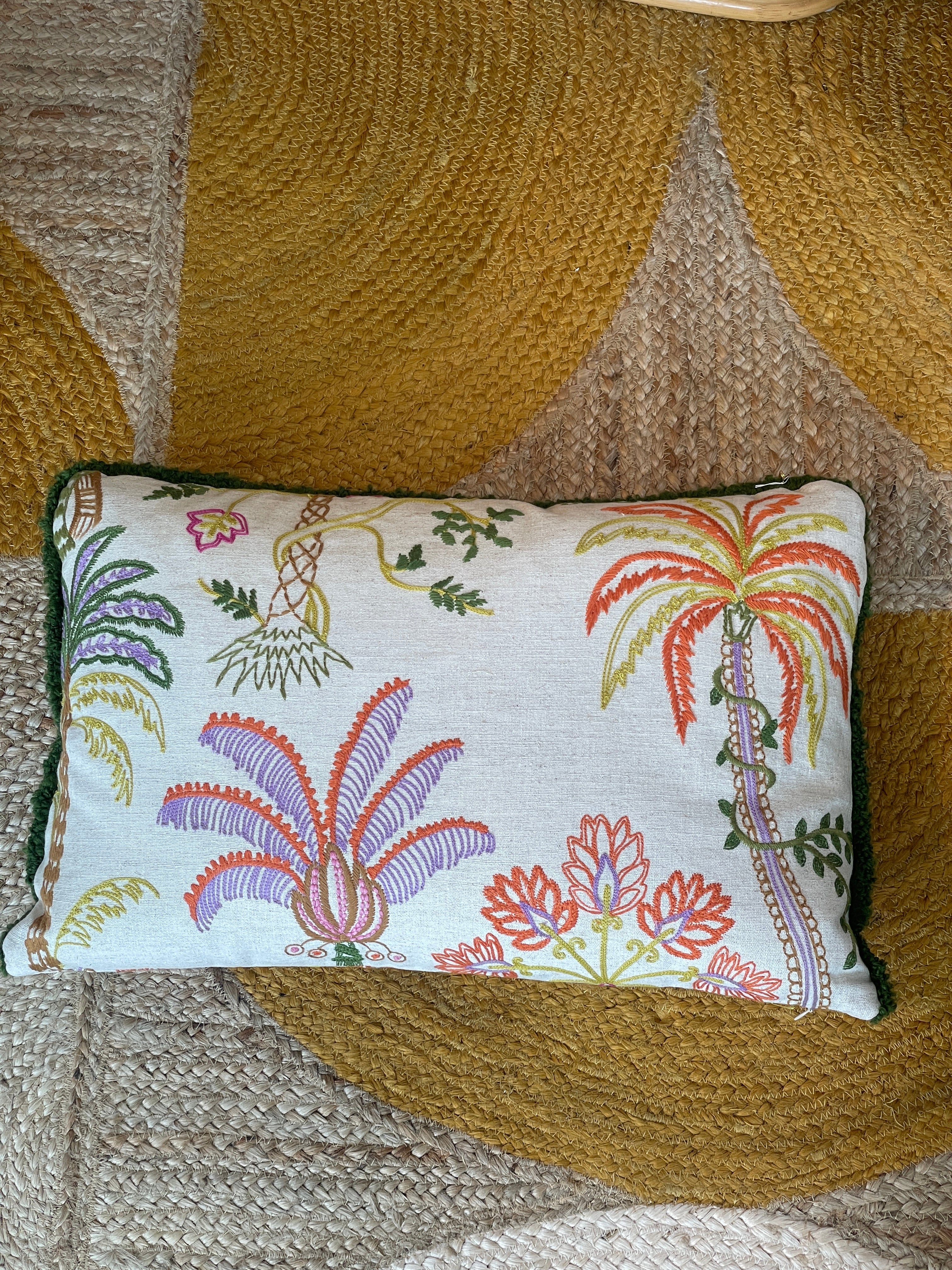 Hand-embroidered cushions with palm motifs